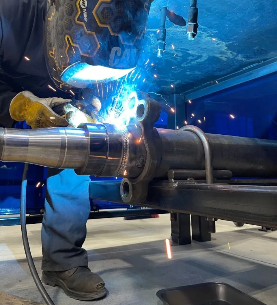 United Axle technician threading a replacement spindle on-site